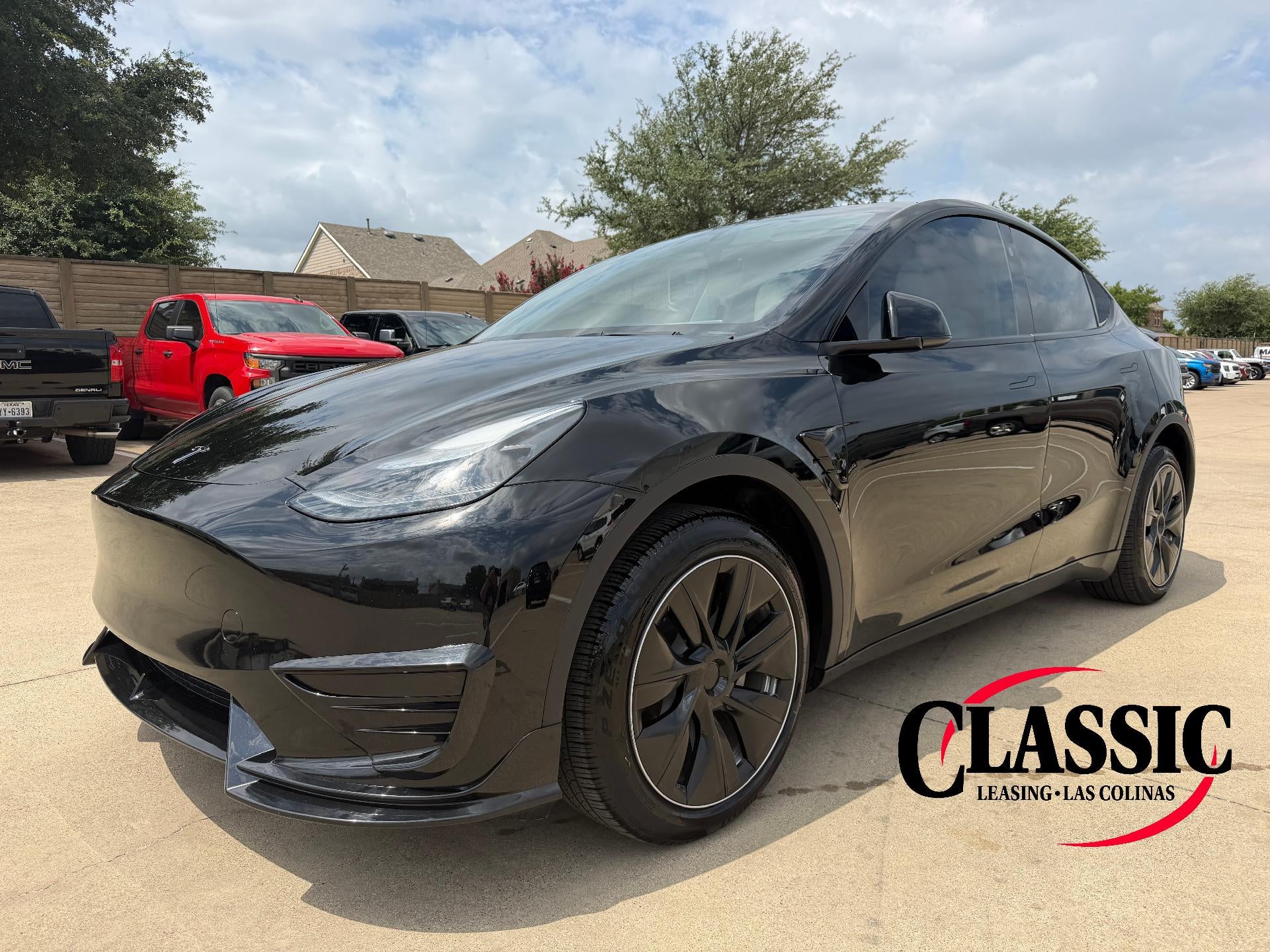 2024 Tesla Model Y Long Range AWD in Solid Black — front three-quarter view